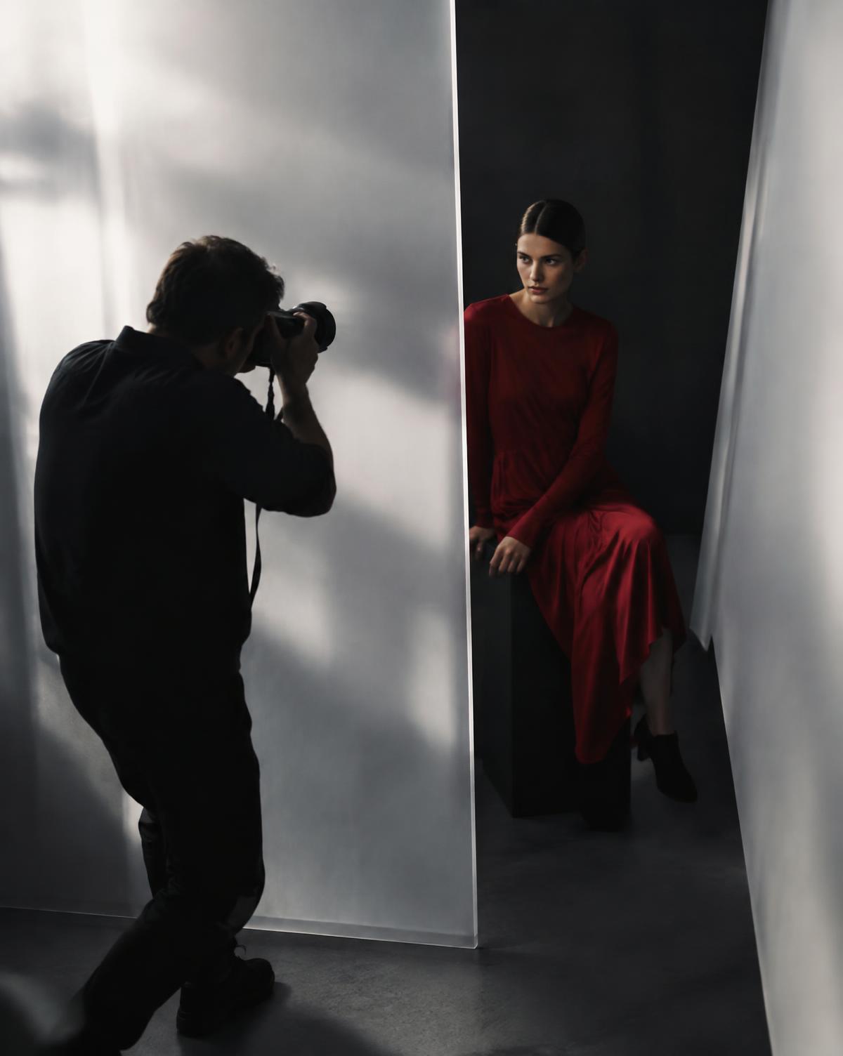 Photographer creating an editorial portrait in a studio