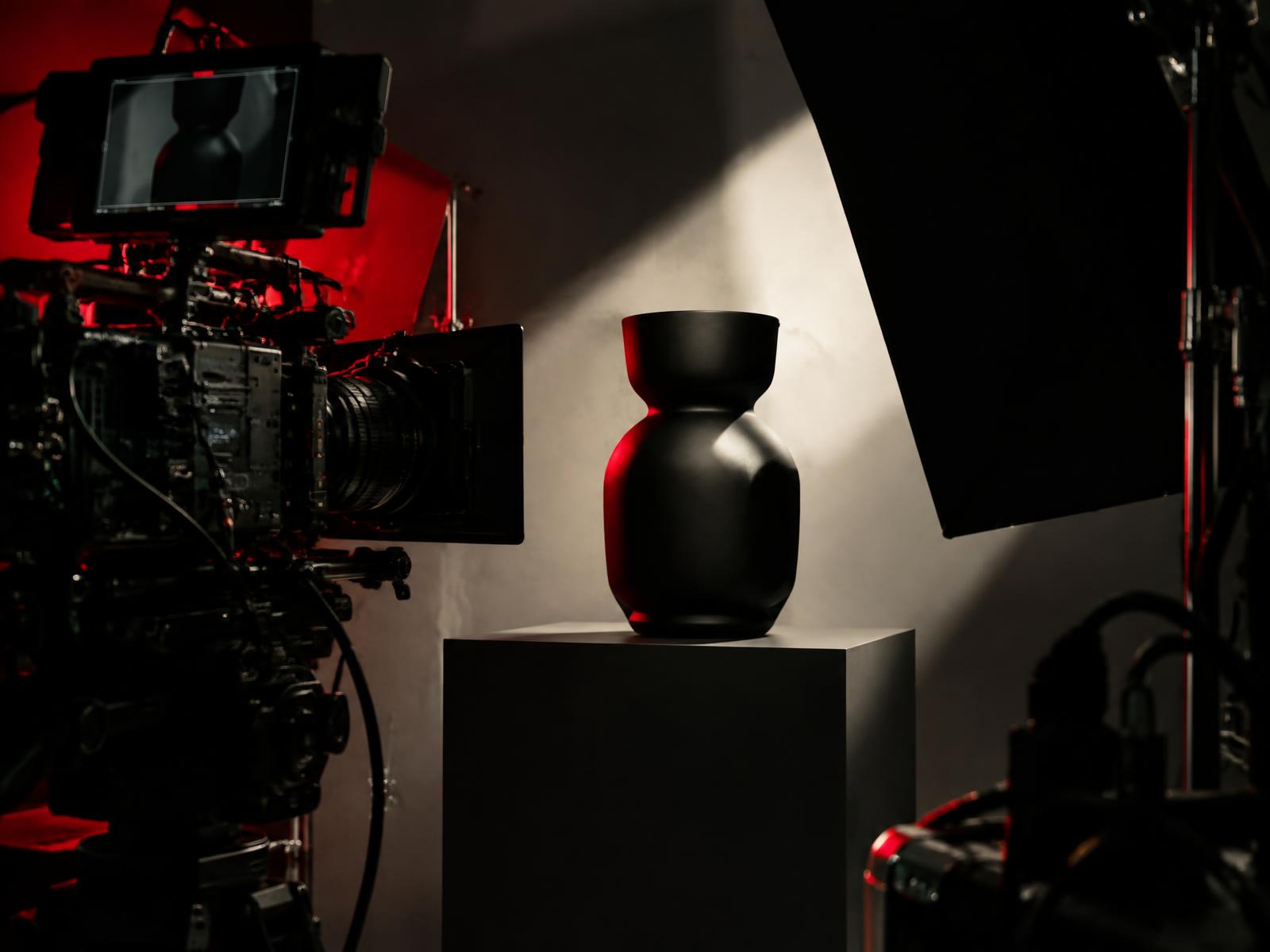 Cinema camera filming a sculptural product on a studio set